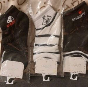 What is Snoopy up to? 2 black pairs & 1 white & stripe pair ankle socks.size 7-9
